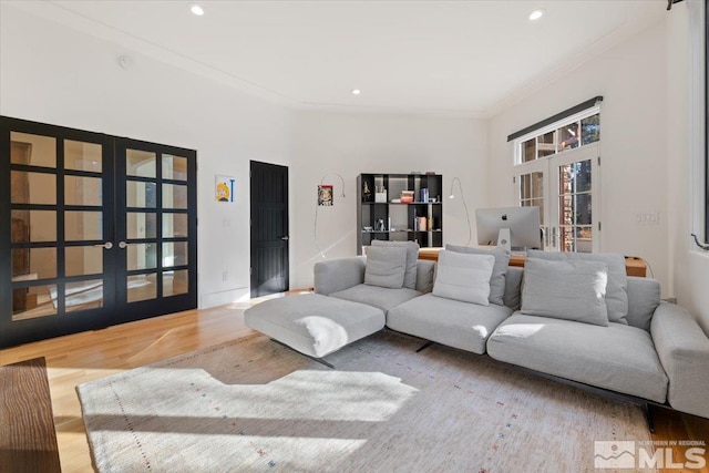 living room with ornamental molding, hardwood / wood-style floors, and french doors