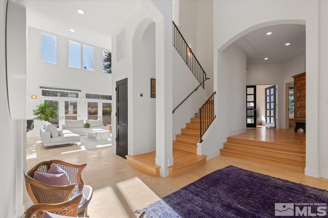 entryway featuring a high ceiling and french doors