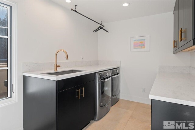 kitchen with sink, washing machine and dryer, and light tile patterned flooring