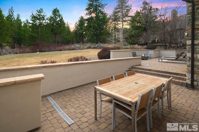 view of patio terrace at dusk