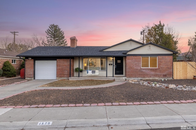 ranch-style house with a porch and a garage