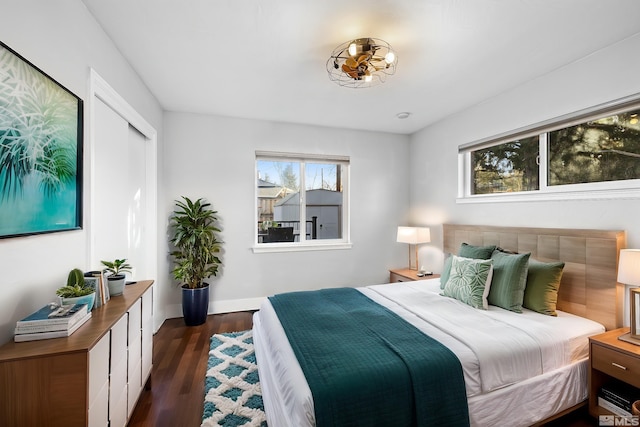 bedroom with dark hardwood / wood-style flooring