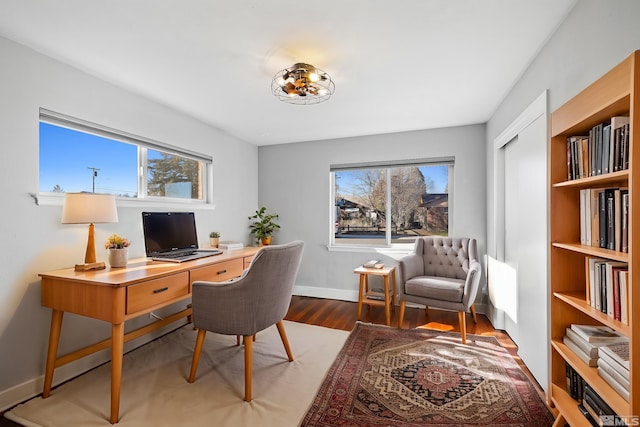 home office with dark hardwood / wood-style floors