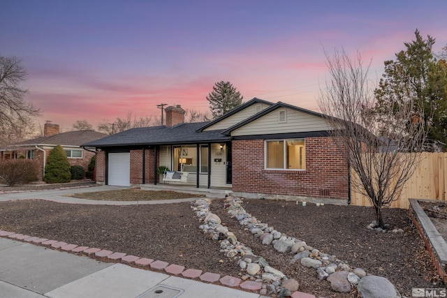 single story home featuring a porch and a garage