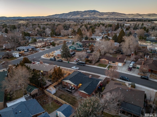 aerial view at dusk featuring a mountain view