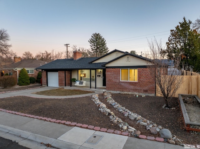 ranch-style house with a porch and a garage