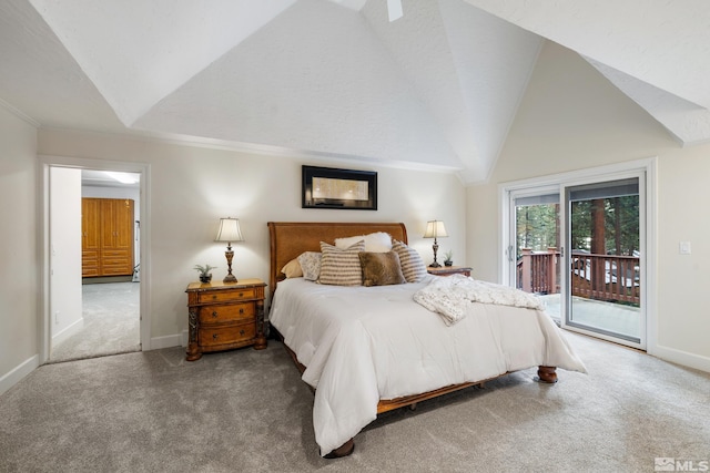 carpeted bedroom with access to exterior and vaulted ceiling