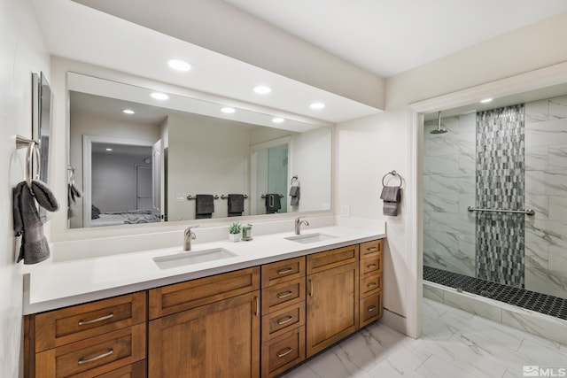 bathroom with a tile shower and vanity