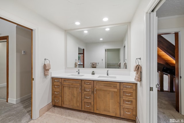 bathroom with vanity, ornamental molding, and tile patterned flooring