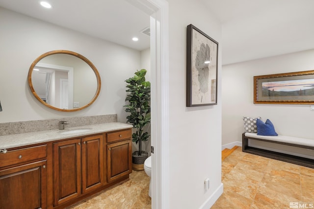 bathroom with toilet and vanity