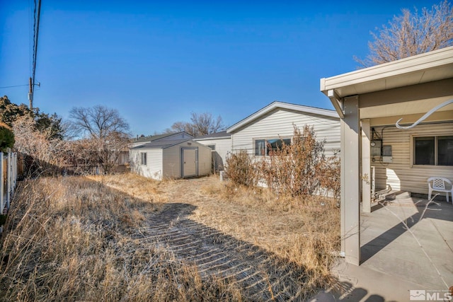 view of yard with a patio area and a storage shed