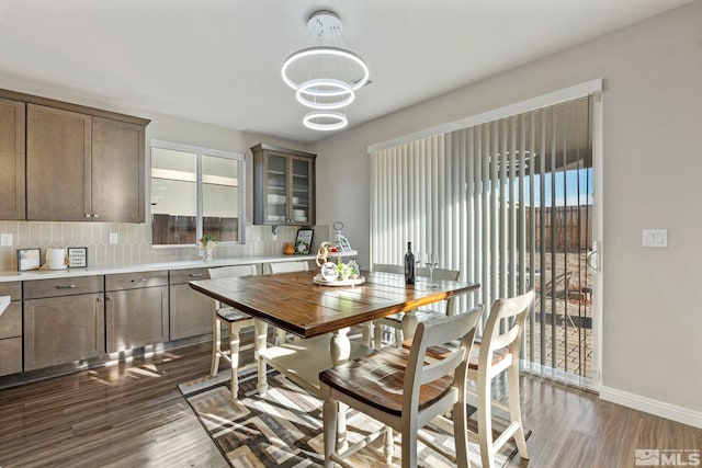 dining space featuring dark hardwood / wood-style floors and a notable chandelier