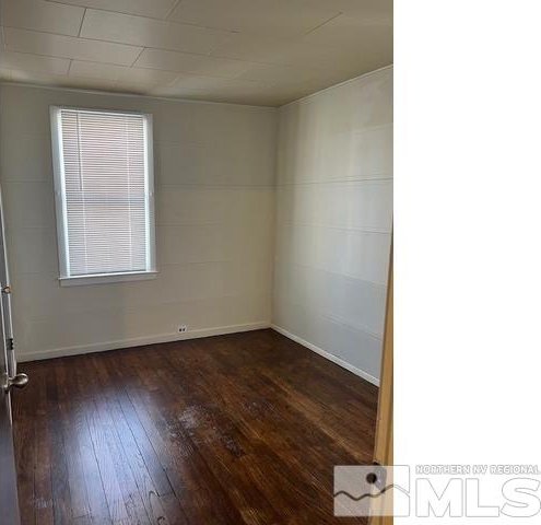 unfurnished room featuring dark hardwood / wood-style flooring