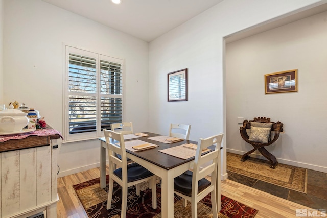 dining space with light wood-type flooring