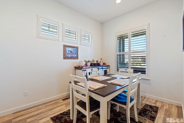 dining space with light hardwood / wood-style floors