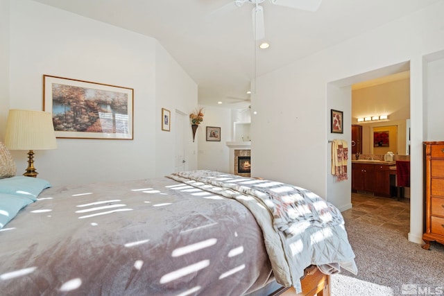 carpeted bedroom featuring ceiling fan and connected bathroom