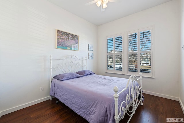 bedroom with ceiling fan and dark hardwood / wood-style flooring