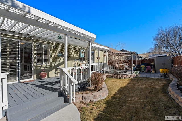 exterior space with a lawn, a patio area, a storage shed, and a pergola