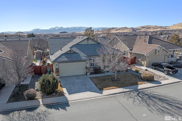 ranch-style house with a mountain view and a garage