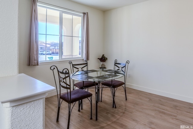 dining area featuring light hardwood / wood-style floors and a wealth of natural light