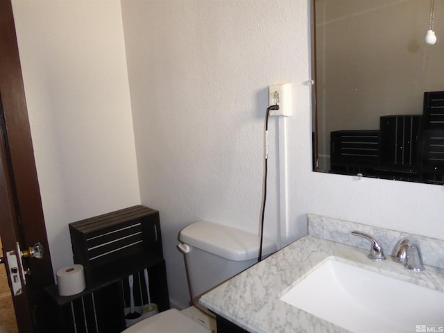 bathroom with toilet and vanity