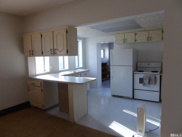 kitchen featuring white appliances and kitchen peninsula