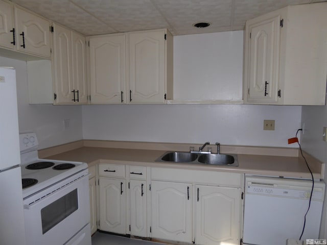 kitchen featuring sink, white appliances, and white cabinets