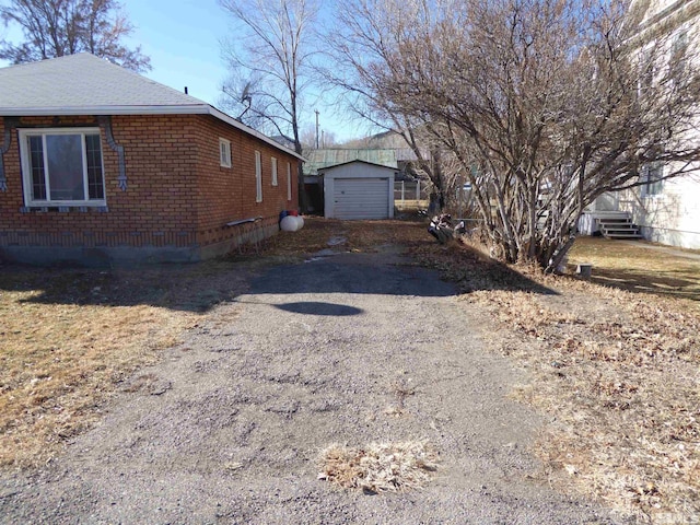 view of property exterior with a garage and an outdoor structure