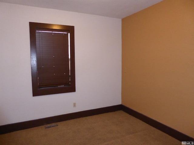 unfurnished room featuring carpet