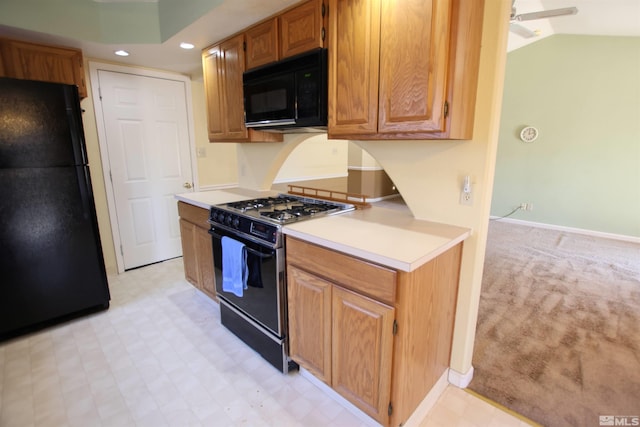 kitchen with ceiling fan, lofted ceiling, black appliances, and light carpet