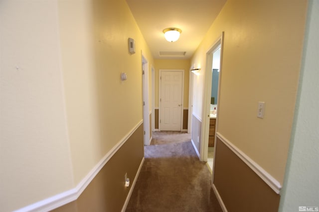 corridor with dark colored carpet