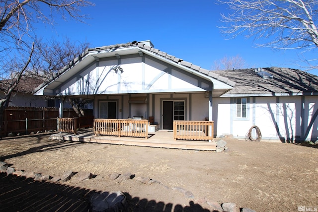 back of property with a wooden deck