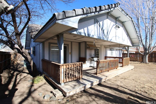 rear view of property featuring a porch