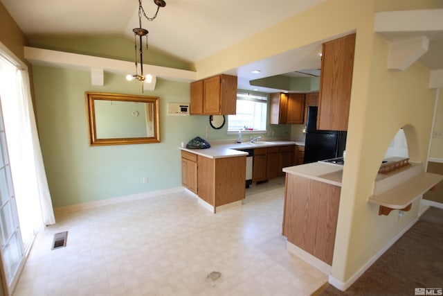 kitchen featuring dishwashing machine, kitchen peninsula, black fridge, pendant lighting, and vaulted ceiling