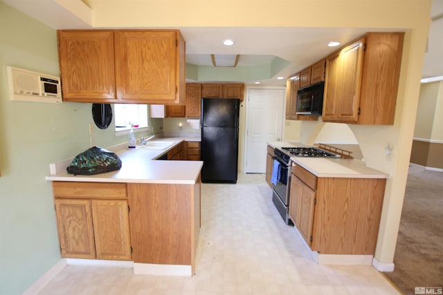 kitchen with sink, black appliances, kitchen peninsula, and a raised ceiling