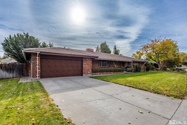 ranch-style home featuring a garage and a front yard