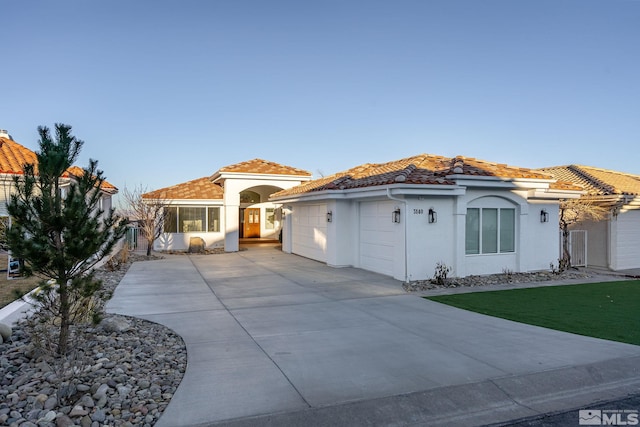 mediterranean / spanish home featuring a garage