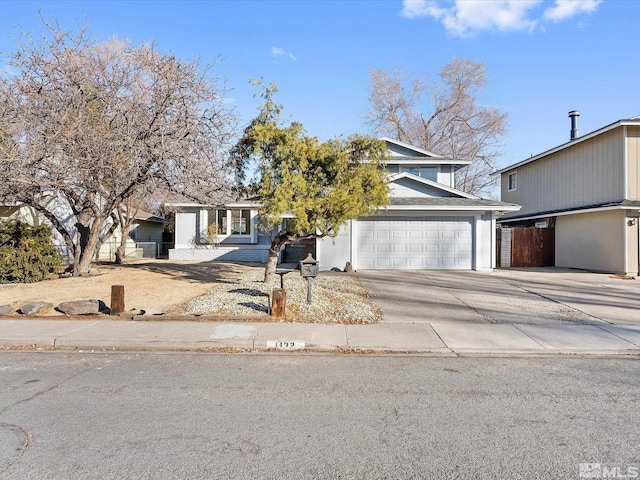 view of property hidden behind natural elements featuring a garage