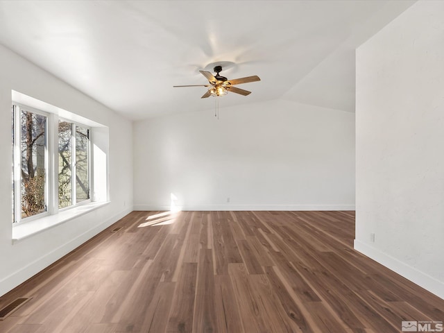 unfurnished room with ceiling fan, dark hardwood / wood-style floors, and lofted ceiling