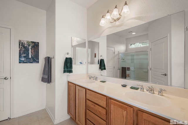 bathroom featuring tile patterned floors, walk in shower, and vanity