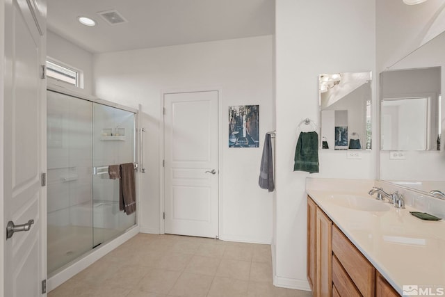 bathroom with a shower with shower door and vanity