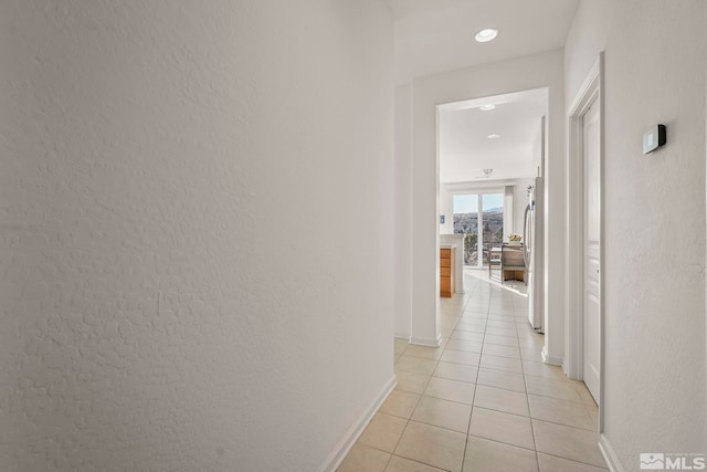 corridor with light tile patterned floors