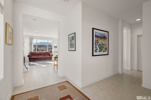 hall featuring light tile patterned floors