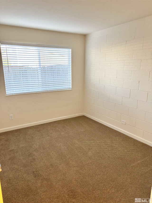 empty room with dark colored carpet