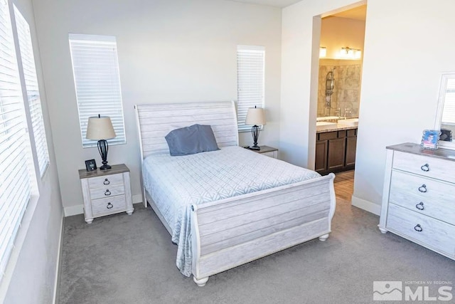 bedroom featuring light colored carpet and ensuite bath