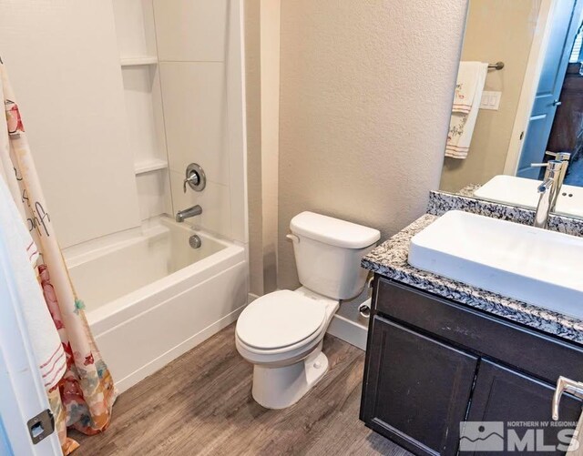 full bathroom with shower / bath combo with shower curtain, hardwood / wood-style floors, toilet, and vanity