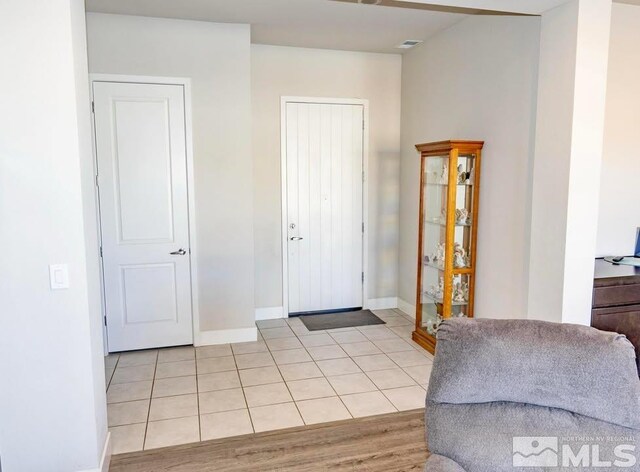 entryway with light tile patterned flooring