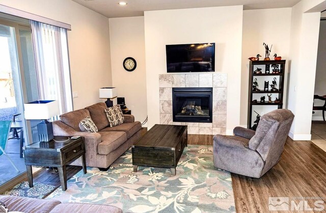 living room with hardwood / wood-style flooring and a fireplace