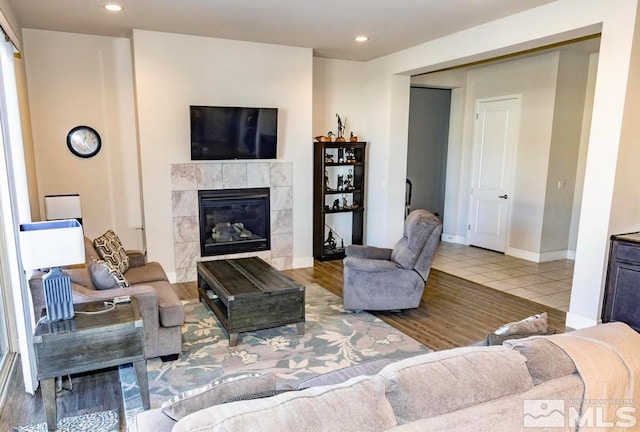 tiled living room with a tiled fireplace