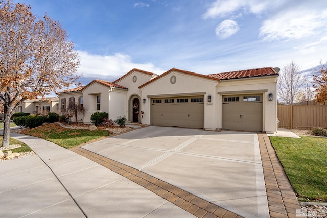 mediterranean / spanish house with a garage